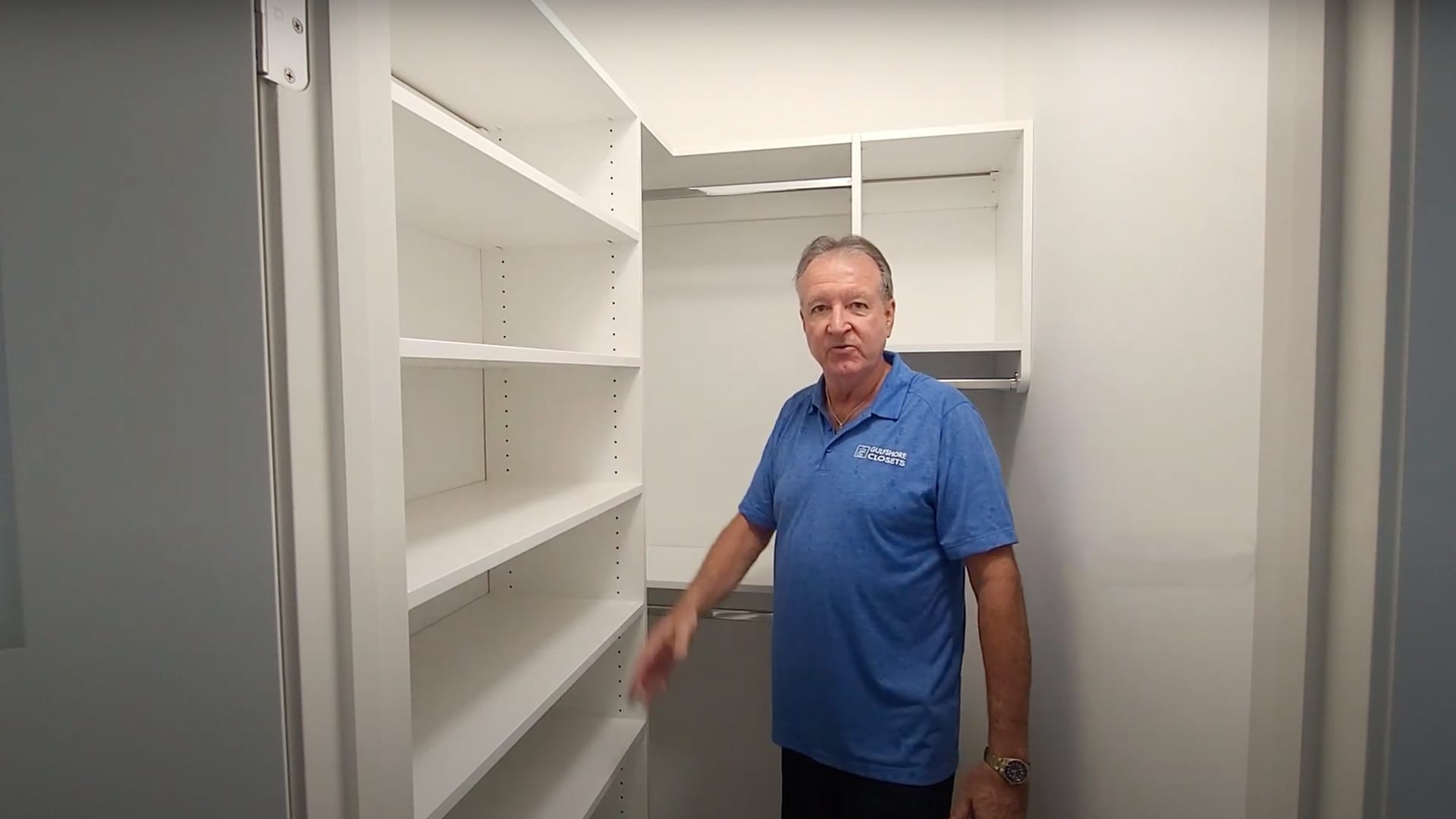 Custom walk-in closet design by Gulfshore Closets, featuring built-in shelving, drawers, and hanging space for optimal organization.